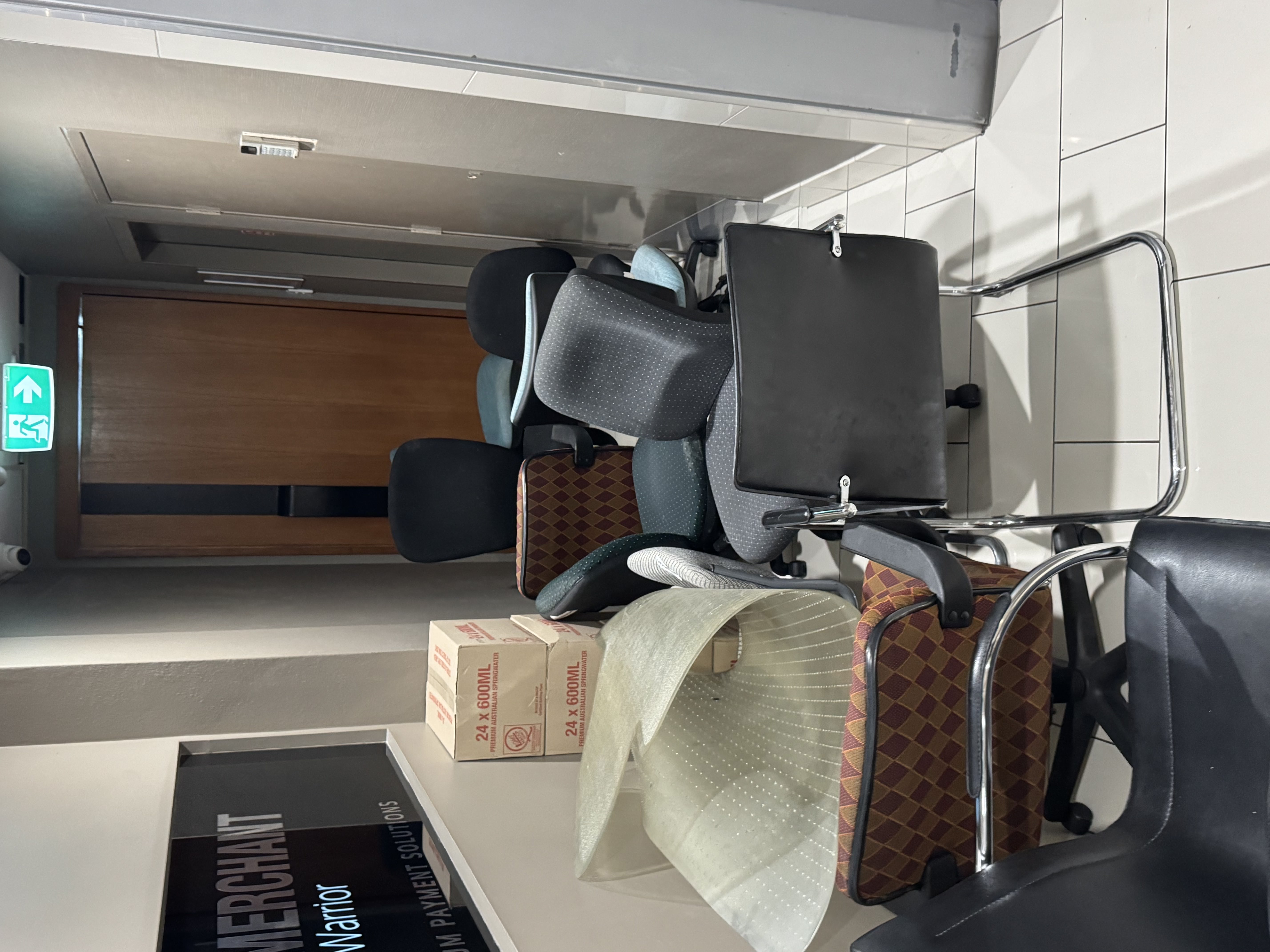 Office furniture stacked for commercial waste removal, Gold Coast